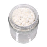 Top view of an open jar filled with Vivimu’s white CBGa isolate powder, a fine hemp-derived bulk cannabinoid extract